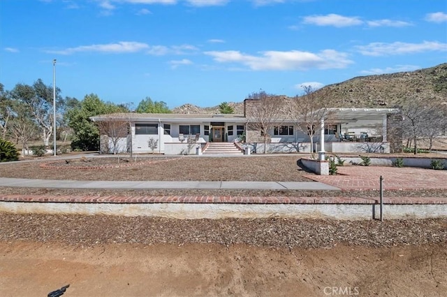 view of front facade with a mountain view and a pergola