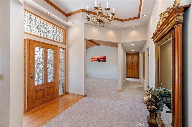 carpeted foyer featuring a high ceiling, crown molding, and recessed lighting