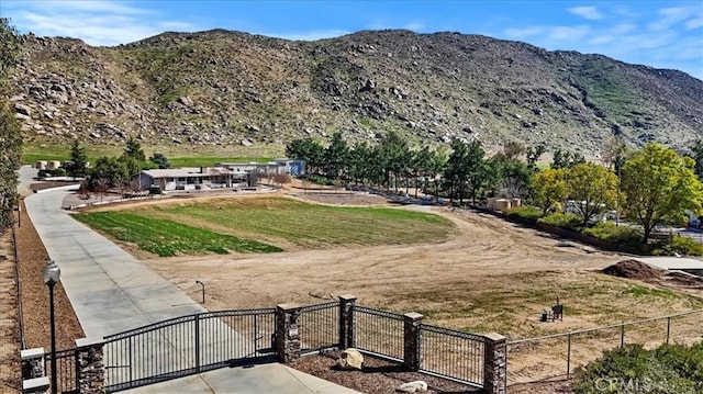 view of property's community featuring fence and a mountain view