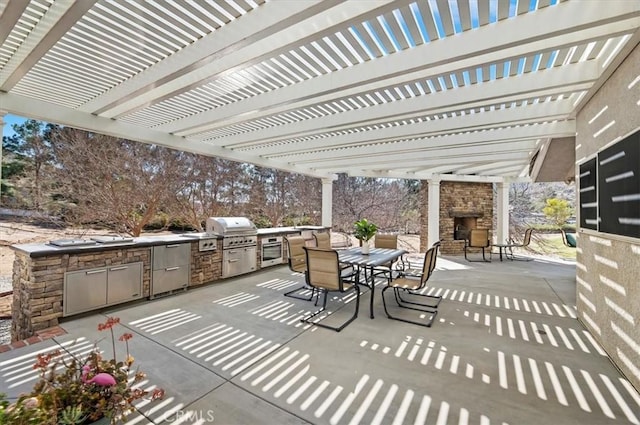 view of patio / terrace featuring outdoor dining space, grilling area, an outdoor kitchen, and an outdoor fireplace