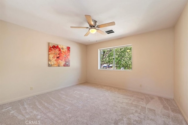 spare room featuring baseboards, ceiling fan, visible vents, and carpet flooring