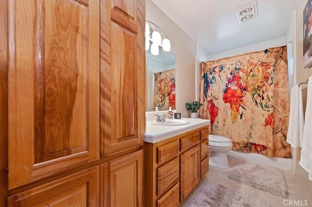 full bathroom featuring vanity and toilet