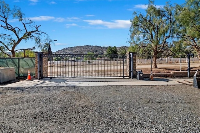 view of gate featuring fence and a mountain view