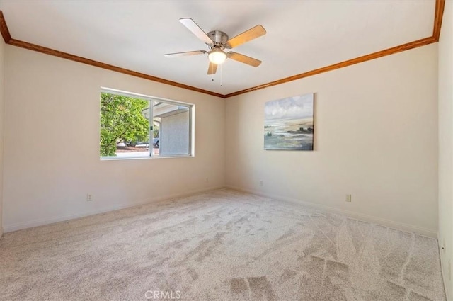 unfurnished room with ceiling fan, carpet floors, ornamental molding, and baseboards