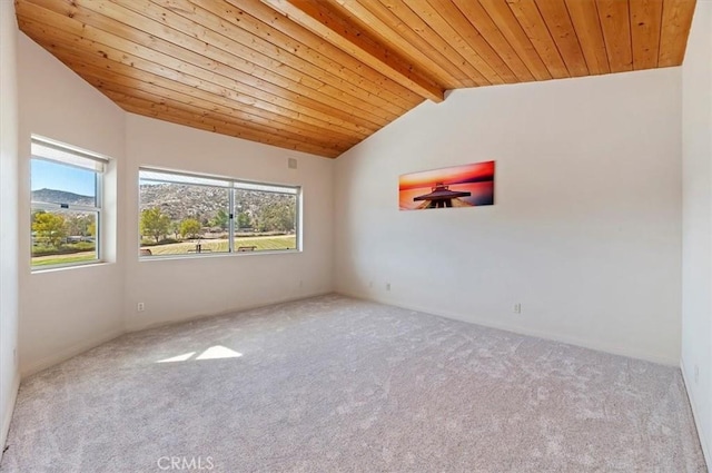 empty room with vaulted ceiling with beams, wood ceiling, and carpet flooring