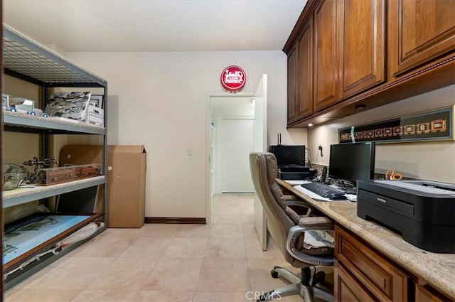 office featuring built in study area and baseboards