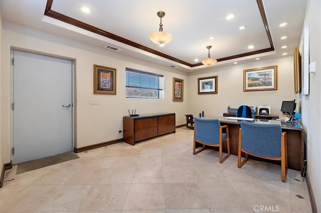 office space featuring ornamental molding, a tray ceiling, visible vents, and baseboards