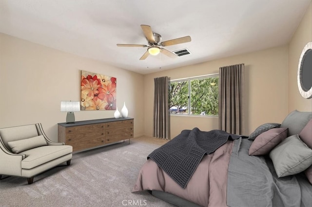 carpeted bedroom featuring visible vents and a ceiling fan