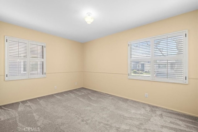 unfurnished room with light colored carpet