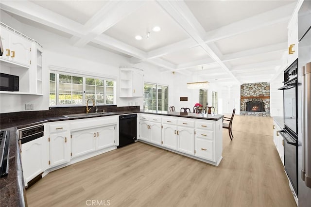 kitchen with open shelves, black appliances, dark countertops, and a sink