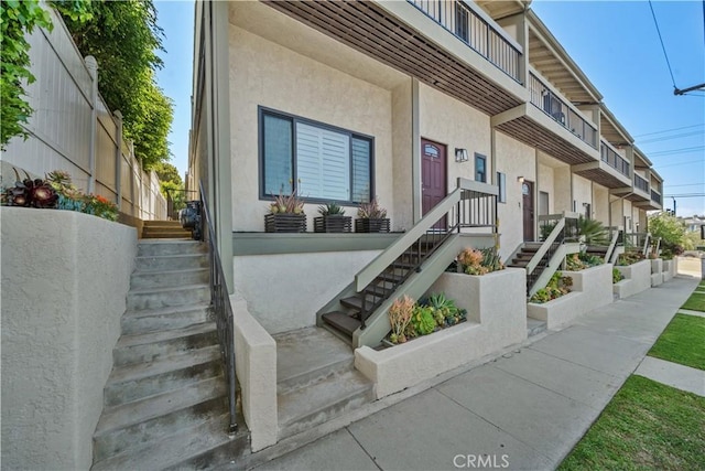 property entrance with stucco siding