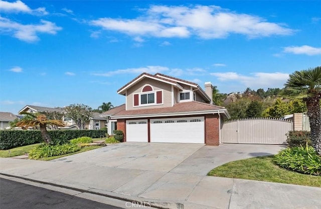 traditional-style home featuring a gate, brick siding, driveway, and an attached garage