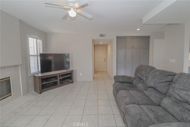 living room featuring visible vents, ceiling fan, a tiled fireplace, recessed lighting, and light tile patterned flooring