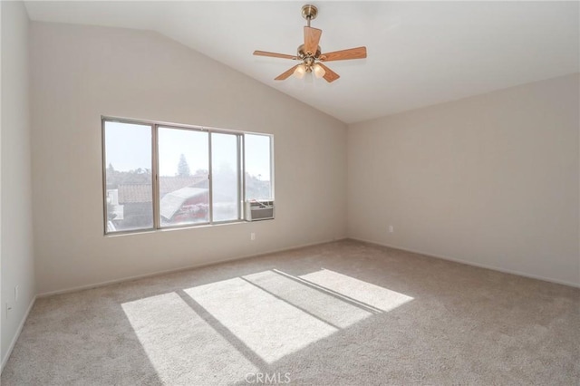 spare room with light carpet, a ceiling fan, and vaulted ceiling