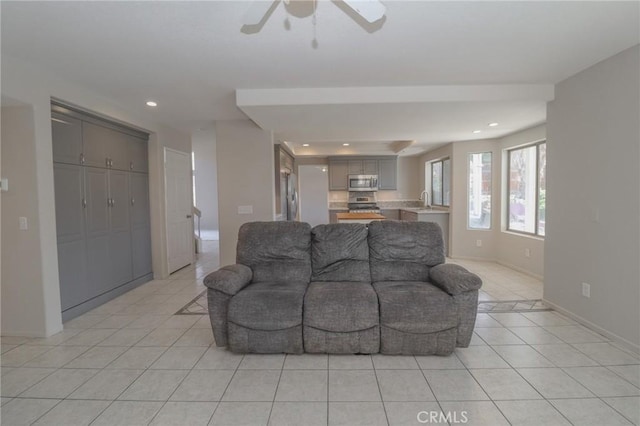 living room featuring light tile patterned floors, recessed lighting, baseboards, and ceiling fan