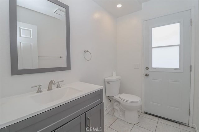 bathroom featuring toilet, vanity, and tile patterned flooring