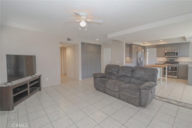 living room with light tile patterned floors, visible vents, recessed lighting, and a ceiling fan