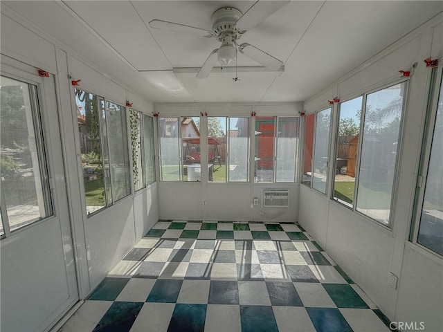 unfurnished sunroom with ceiling fan