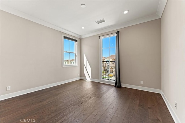 unfurnished room with recessed lighting, visible vents, baseboards, ornamental molding, and dark wood finished floors