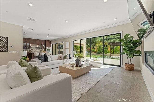 living room featuring ornamental molding, recessed lighting, visible vents, and baseboards