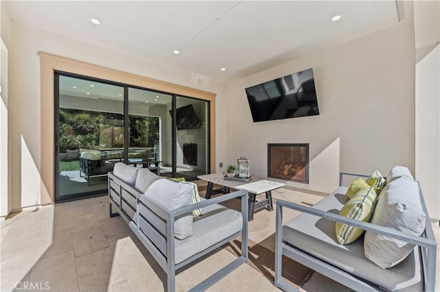 view of patio featuring an outdoor living space with a fireplace and visible vents