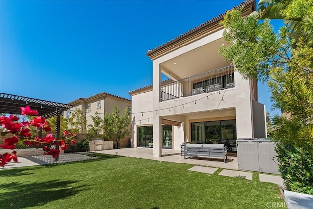 rear view of house featuring an outdoor hangout area, a patio, a balcony, and stucco siding