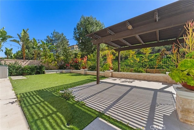 exterior space featuring a patio area, a fenced backyard, and a pergola