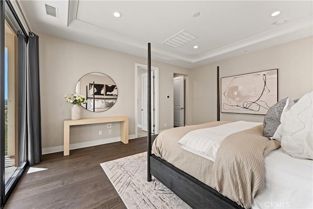 bedroom featuring dark wood-type flooring, a raised ceiling, visible vents, and recessed lighting