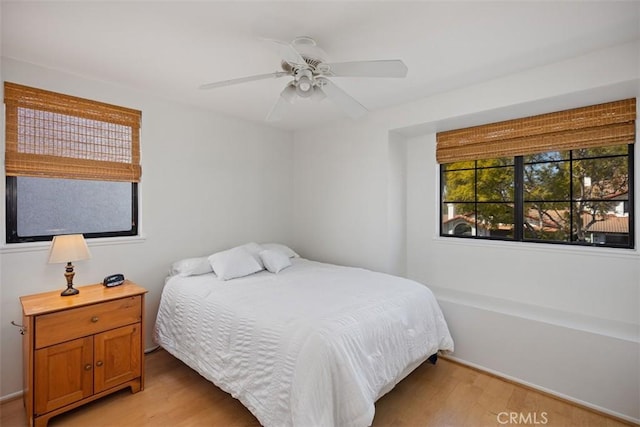 bedroom with ceiling fan and light wood-style floors