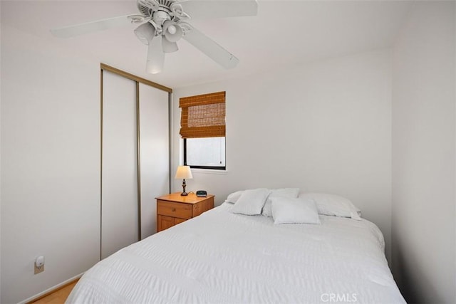 bedroom with ceiling fan and a closet