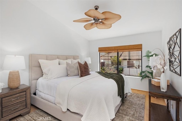 bedroom with vaulted ceiling, ceiling fan, and wood finished floors