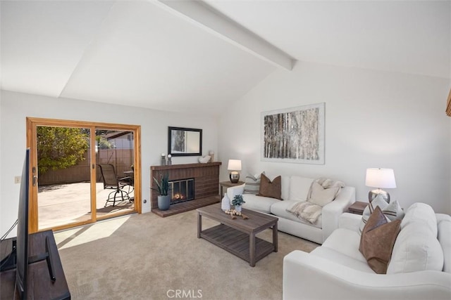 living room featuring a brick fireplace, light colored carpet, and vaulted ceiling with beams