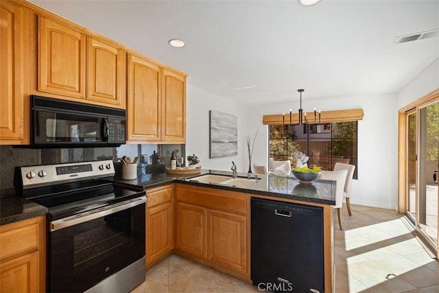 kitchen with visible vents, a sink, dark stone countertops, a peninsula, and black appliances