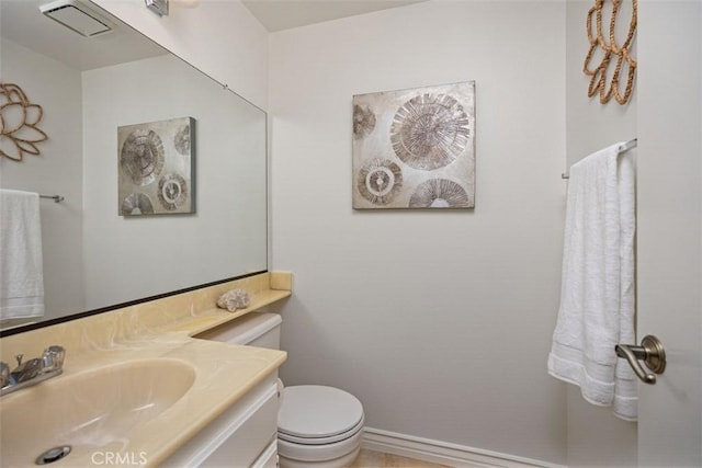 bathroom with toilet, baseboards, visible vents, and vanity