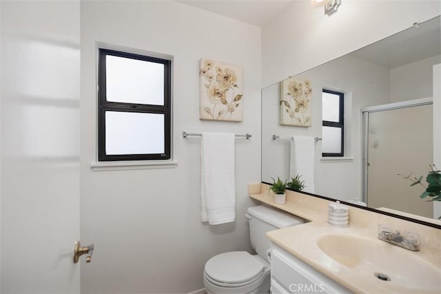 full bathroom with vanity, an enclosed shower, and toilet