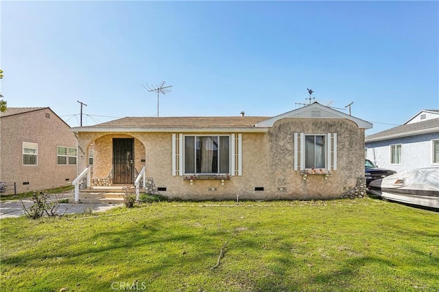 view of front of property featuring a front lawn, crawl space, and stucco siding