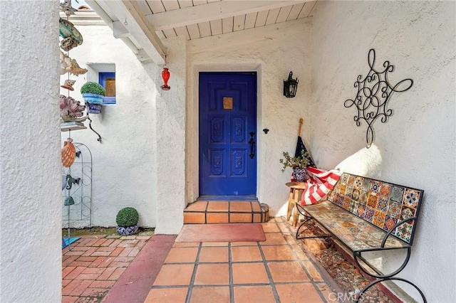 entrance to property featuring stucco siding