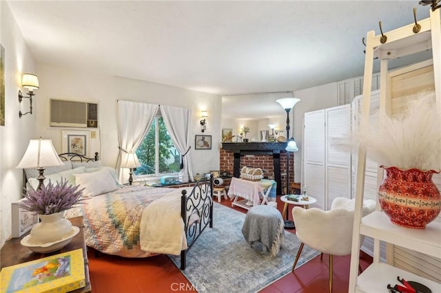 bedroom with a fireplace and an AC wall unit