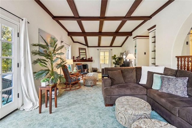 carpeted living room with lofted ceiling with beams and arched walkways