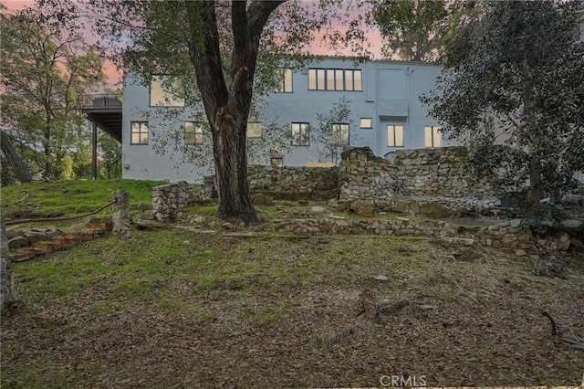 back of property featuring stucco siding