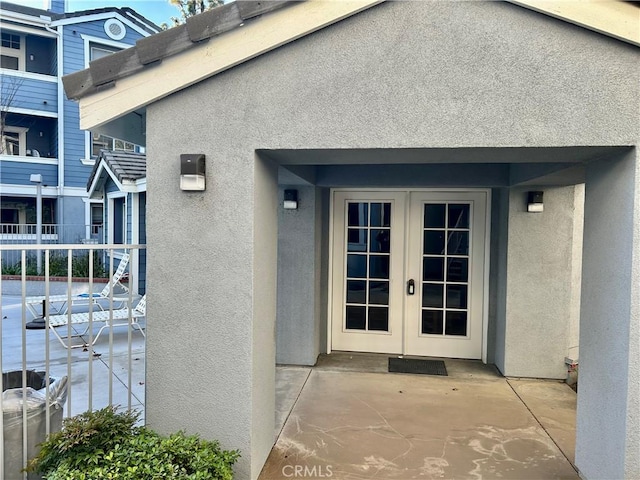 doorway to property with french doors and stucco siding