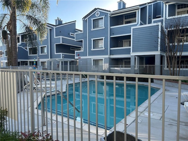 view of swimming pool featuring fence