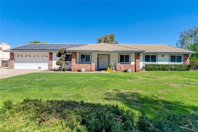 ranch-style home featuring a garage, driveway, brick siding, and a front yard