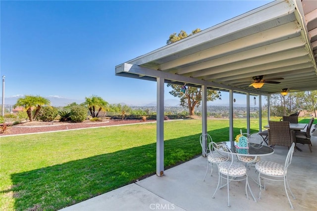 view of patio with outdoor dining space and a ceiling fan