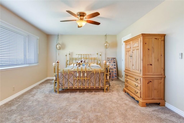 bedroom with baseboards, ceiling fan, and light colored carpet