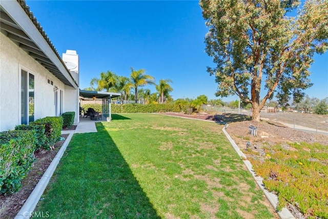 view of yard featuring a patio area and fence