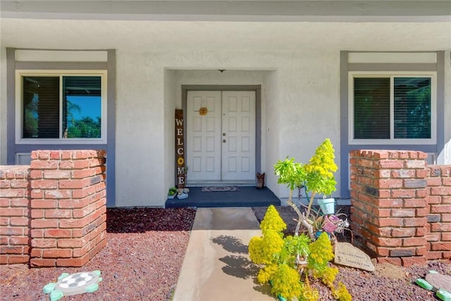 view of exterior entry with stucco siding