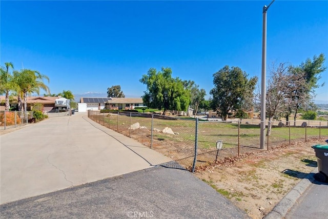 view of front of home featuring driveway and fence