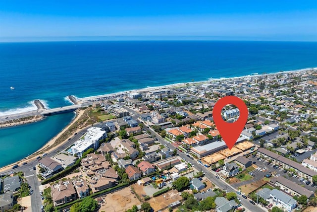 bird's eye view featuring a water view, a view of the beach, and a residential view