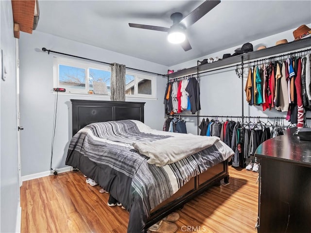 bedroom with ceiling fan and wood finished floors